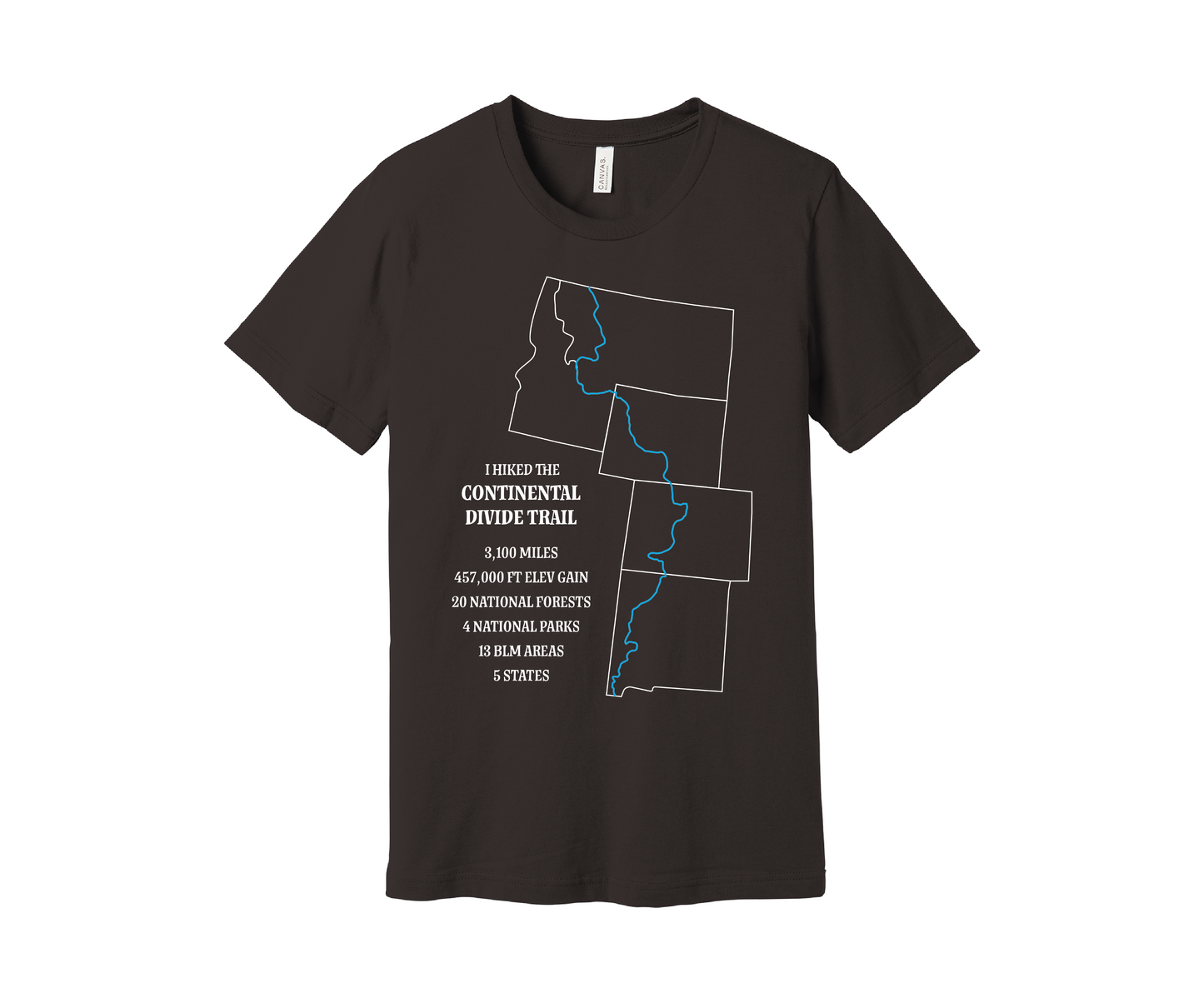 A brown T-shirt displays a white outline of Arizona, Colorado, Montana, Wyoming and Idaho with the route of the Continental Divide Trail marked by a blue line. Text reads, "I hiked the Continental Divide Trail - 3,100 miles, 457,000 ft of elevation gain, 30 national forests, 4 national parks, 13 BLM areas, 5 states.