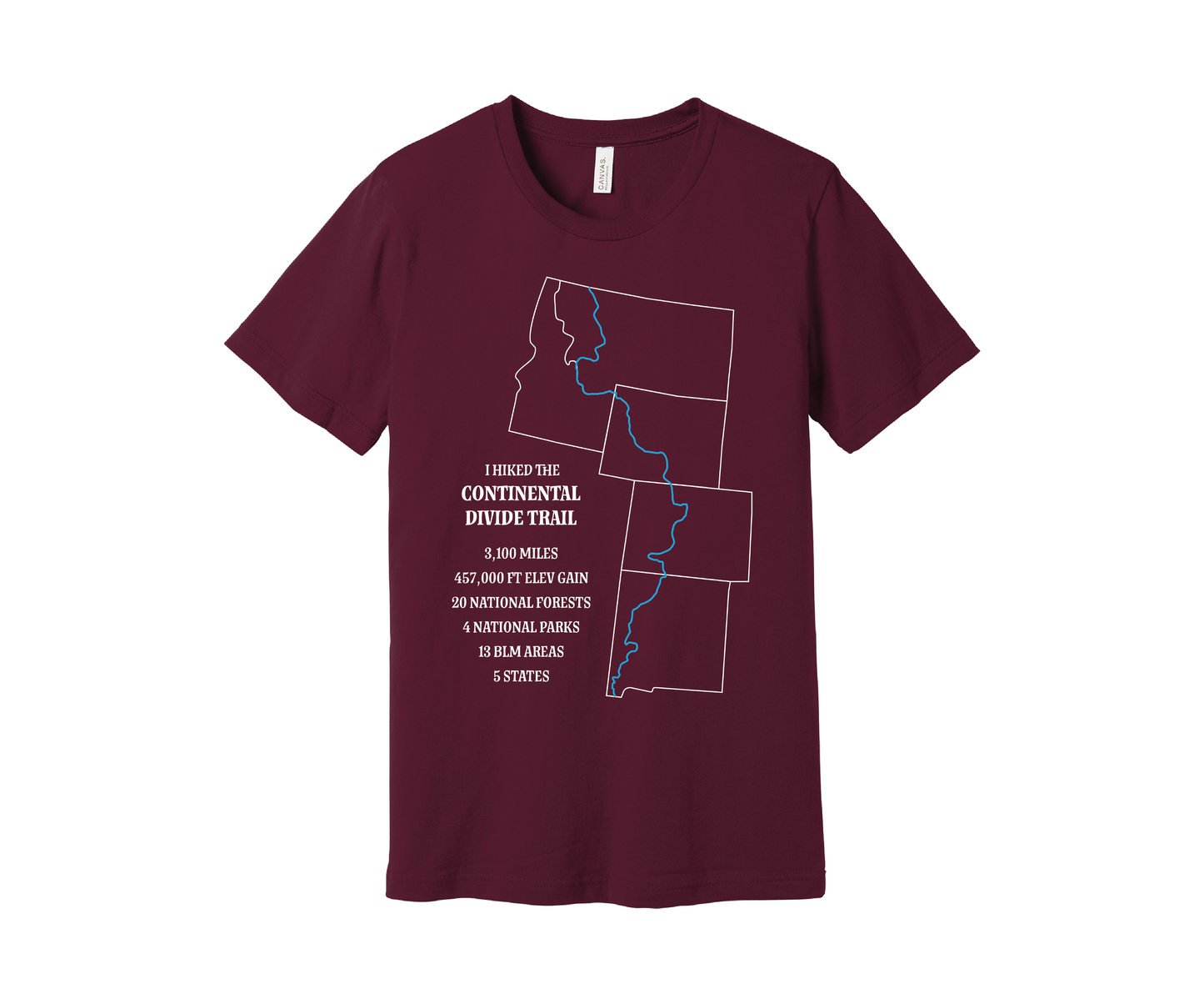 A maroon T-shirt displays a white outline of Arizona, Colorado, Montana, Wyoming and Idaho with the route of the Continental Divide Trail marked by a blue line. Text reads, "I hiked the Continental Divide Trail - 3,100 miles, 457,000 ft of elevation gain, 30 national forests, 4 national parks, 13 BLM areas, 5 states.