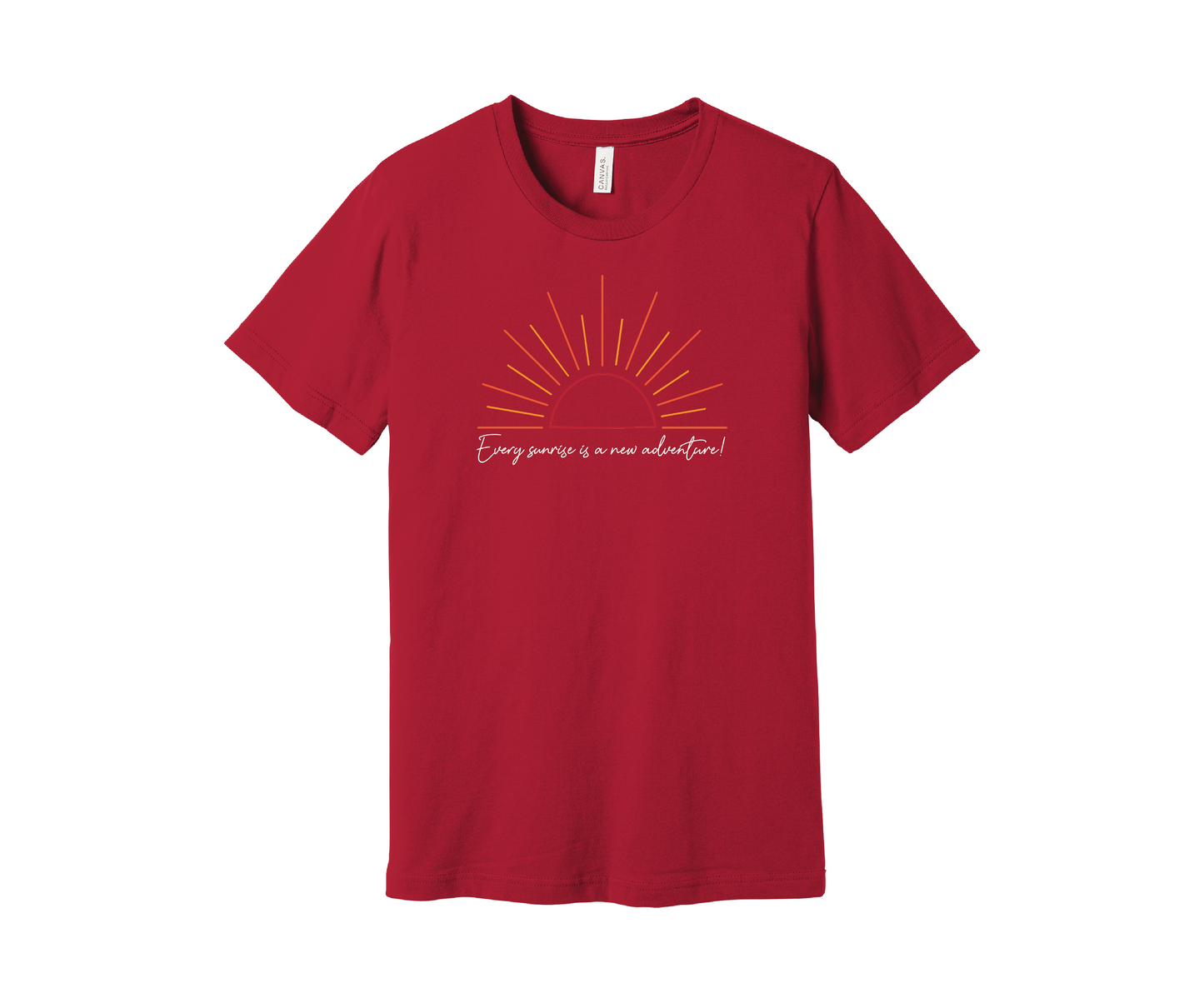 A red T-shirt features a graphic of a stylized orange and yellow sunrise above a handwritten cursive message in white that reads, "Every sunrise is a new adventure!" The shirt has a simple and modern design.