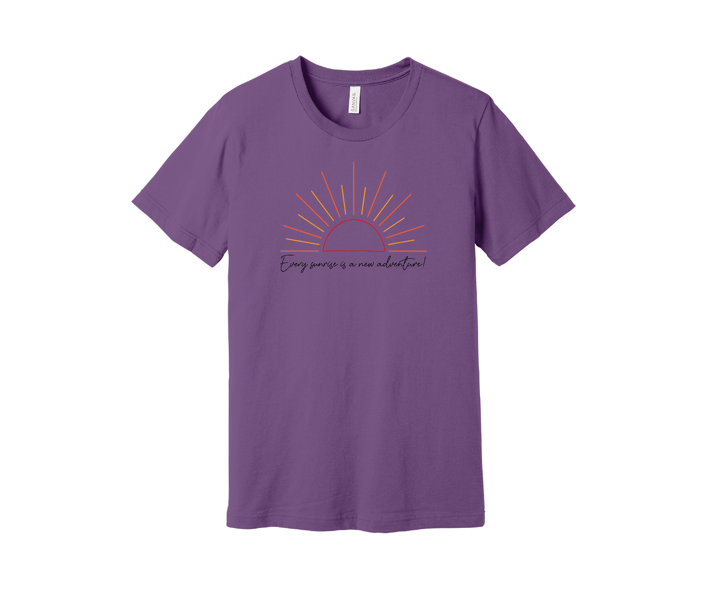 A purple T-shirt features a graphic of a stylized orange and yellow sunrise above a handwritten cursive message in black that reads, "Every sunrise is a new adventure!" The shirt has a simple and modern design.