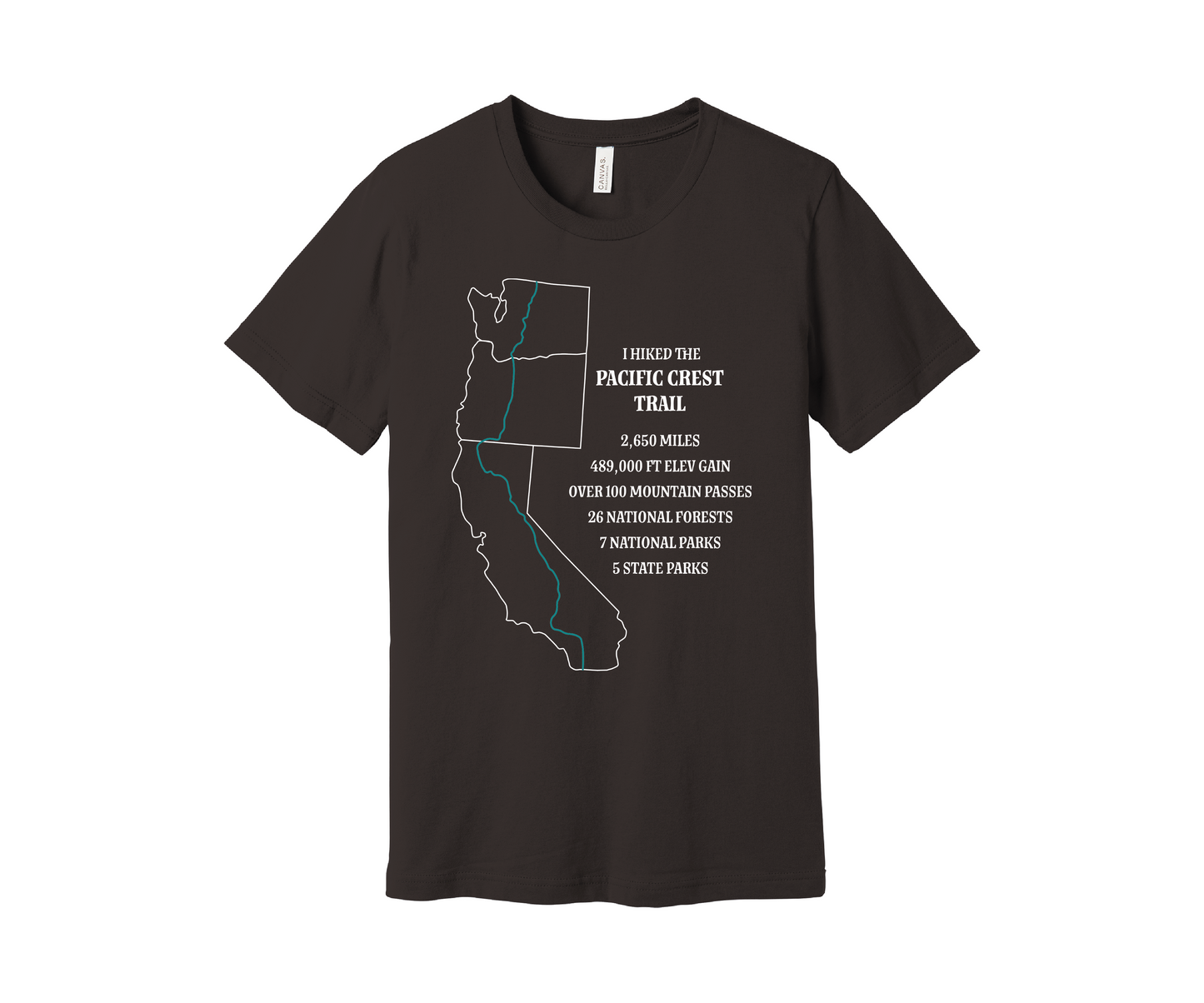 A brown T-shirt displays a white map outline of the states of California, Oregon and washington and the route of the Pacific Crest Trail in teal. Text on the shirt reads: "I Hiked the Pacific Crest Trail," and lists details: 2,650 miles, 489,500 ft elevation gain, Over 60 Mountain Passes, 28 National Forests, 7 National Parks, 5 State Parks.