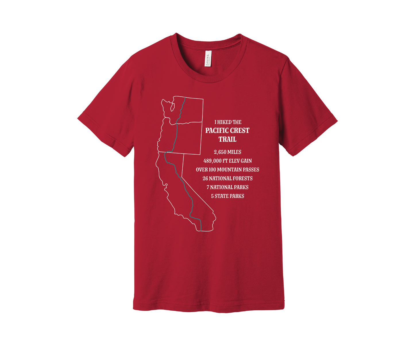 A red T-shirt displays a white map outline of the states of California, Oregon and Washington and the route of the Pacific Crest Trail in teal. Text on the shirt reads: "I Hiked the Pacific Crest Trail," and lists details: 2,650 miles, 489,500 ft elevation gain, Over 60 Mountain Passes, 28 National Forests, 7 National Parks, 5 State Parks.