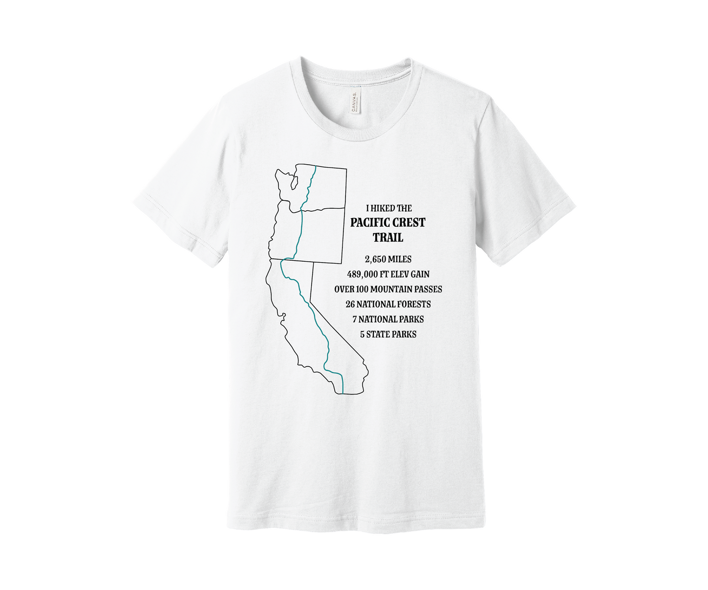 A white T-shirt displays a black map outline of the states of California, Oregon and Washington and the route of the Pacific Crest Trail in teal. Text on the shirt reads: "I Hiked the Pacific Crest Trail," and lists details: 2,650 miles, 489,500 ft elevation gain, Over 60 Mountain Passes, 28 National Forests, 7 National Parks, 5 State Parks.